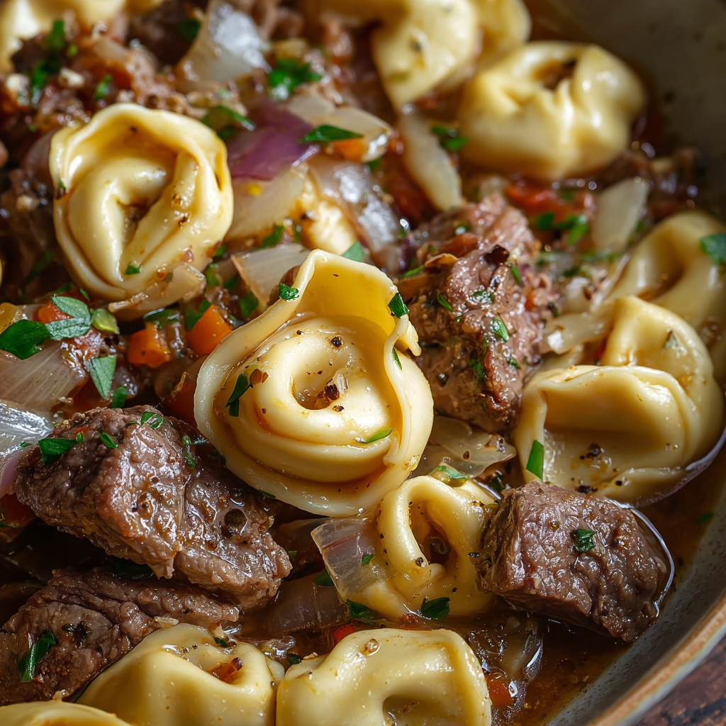 Meal prep containers filled with French onion beef pasta